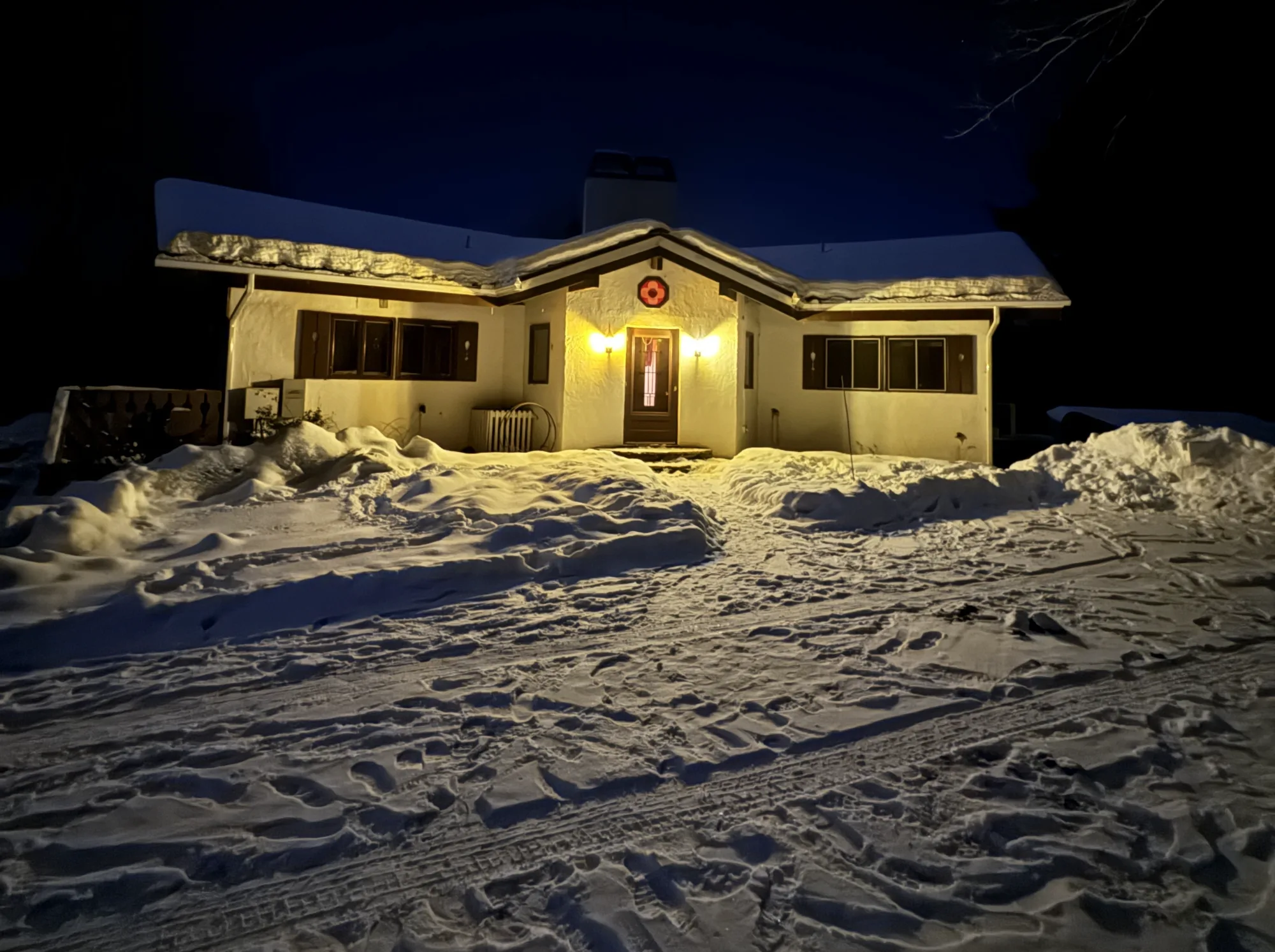 The chalet glowing on a snowy winter night