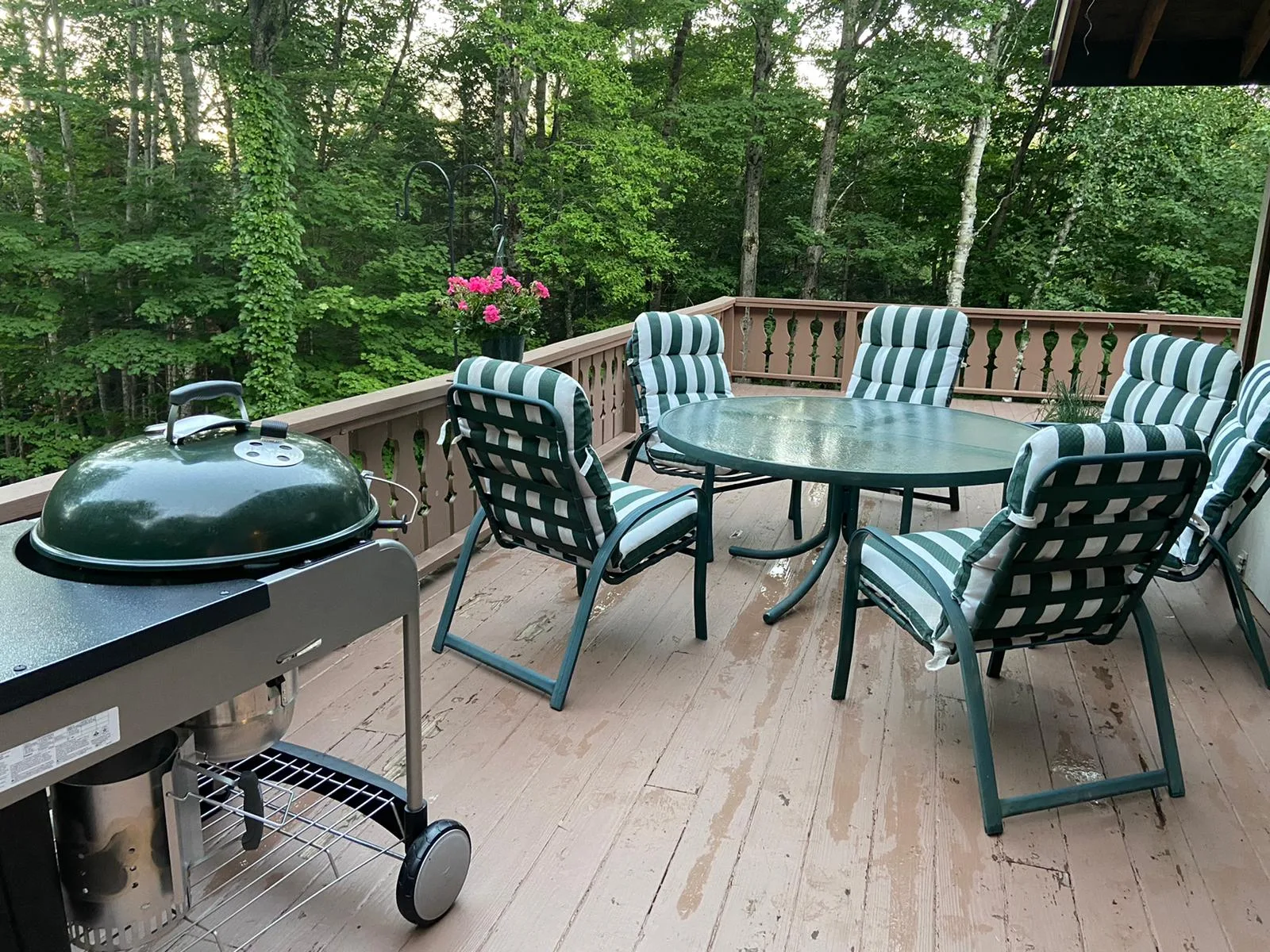 The grill and dining chairs on the deck