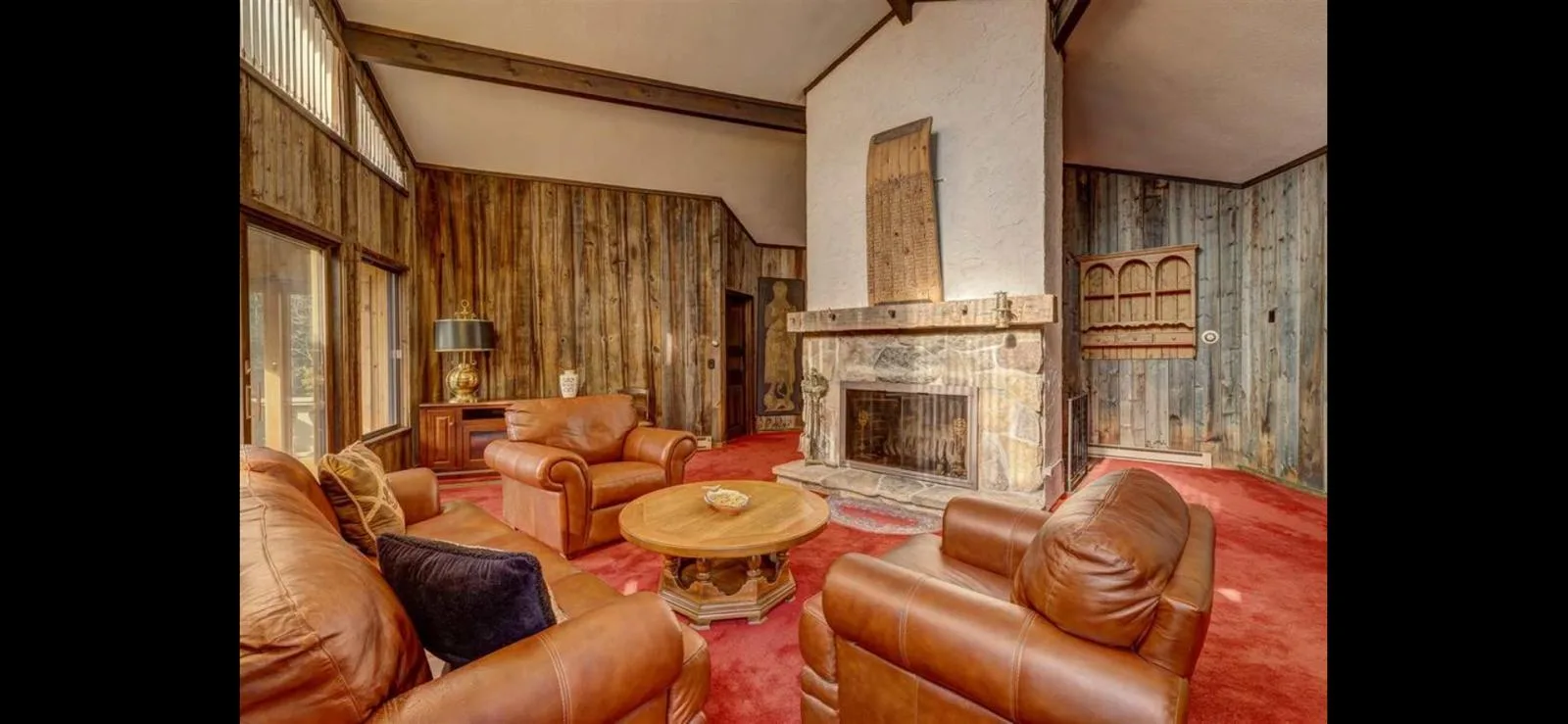 The stone fireplace and leather seating in the great room