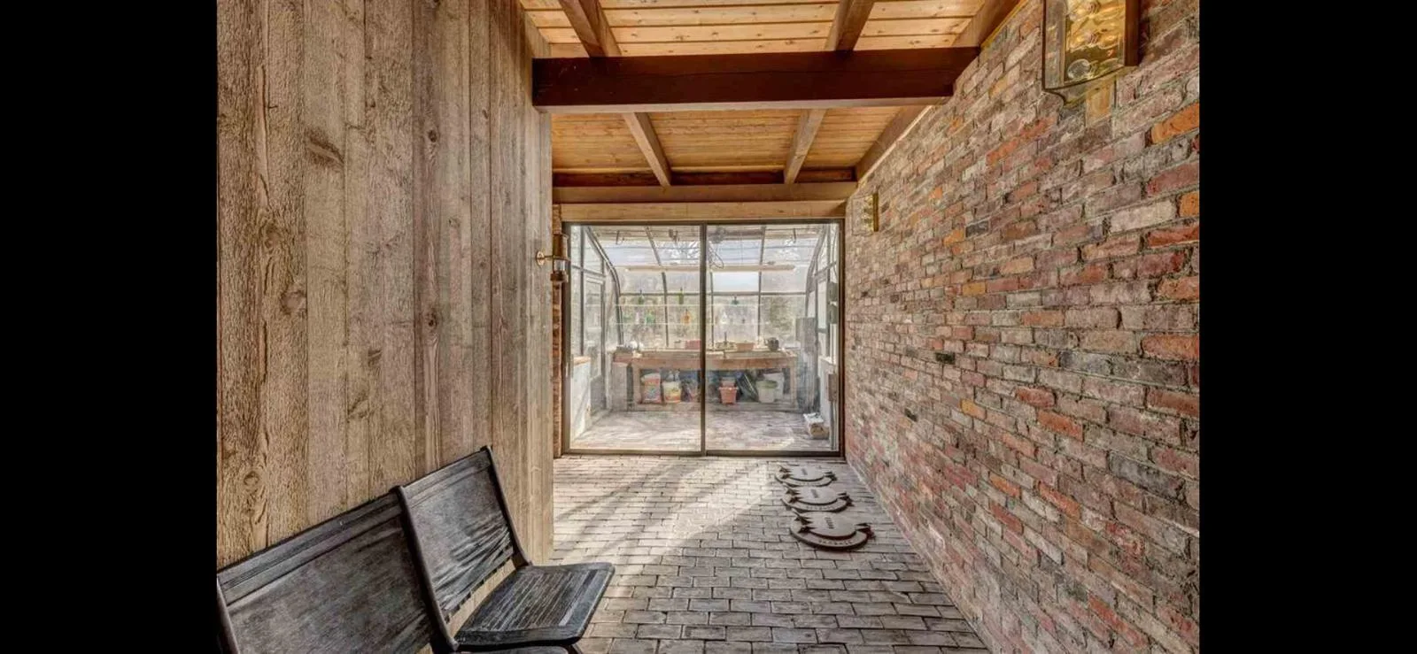 The brick passage leading to the greenhouse
