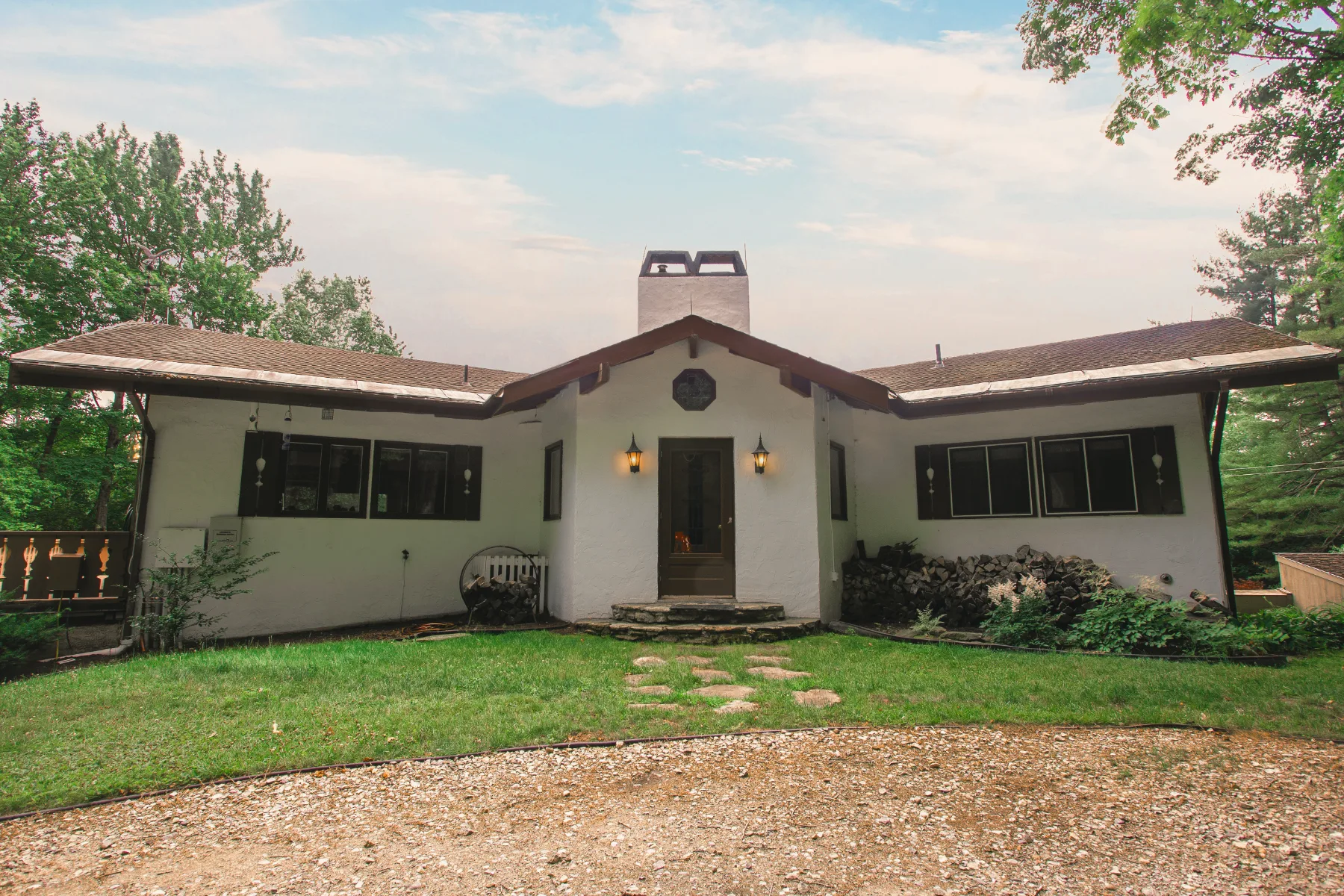 The chalet's white stucco facade from the lawn